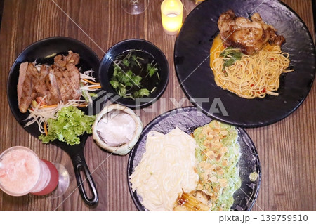 Delicious Asian Cuisine Plated on Dark Plates 139759510