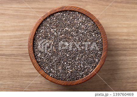 Healthy organic chia seeds in a wooden bowl on a wooden background Healthy organic chia seeds in a wooden bowl on a wooden background 139760469