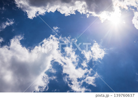 Photo of shining sun through vibrant fluffy clouds Photo of shining sun through vibrant fluffy clouds 139760637