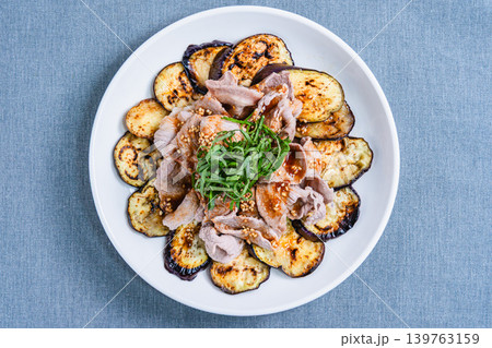テーブルの上に置かれた焼きなすの豚しゃぶのせ 139763159