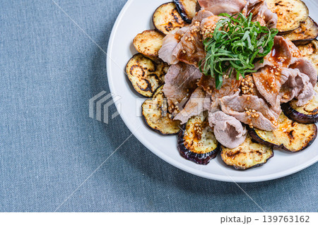 テーブルの上に置かれた焼きなすの豚しゃぶのせ テーブルの上に置かれた焼きなすの豚しゃぶのせ 139763162