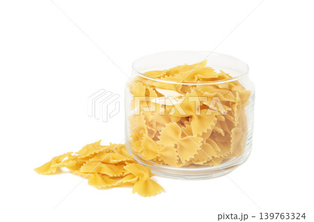 Raw farfalle pasta on glass jar isolated on white background. 139763324