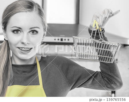 Woman holding small tiny shopping basket Woman holding small tiny shopping basket 139765556