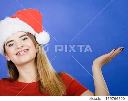 Positive woman wearing Santa Claus helper costume Positive woman wearing Santa Claus helper costume 139766800