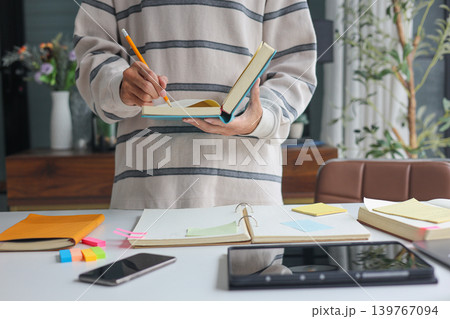 Productive morning routine of a remote worker planning tasks at desk. Productive morning routine of a remote worker planning tasks at desk. 139767094