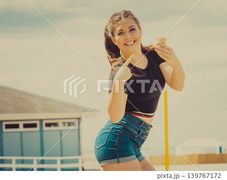 Young woman eating ice cream 139767172