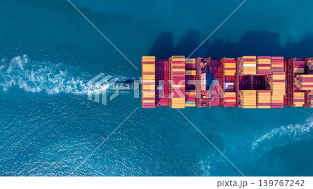 Container ship carrying container for import and export freight, Global business logistic and transportation by container ship boat in open sea, Aerial view container cargo freight ship. 139767242