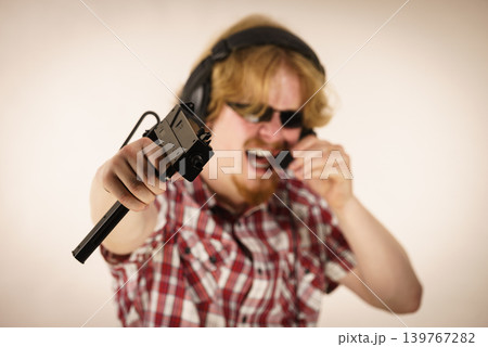 Gamer man shooting from gun Gamer man shooting from gun 139767282