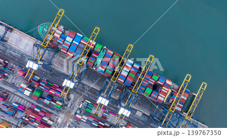 Container ship carrying container box in import export with quay crane, Global business cargo freight shipping commercial trade logistic and transportation oversea worldwide by container vessel. Container ship carrying container box in import export with quay crane, Global business cargo freight shipping commercial trade logistic and transportation oversea worldwide by container vessel. 139767350