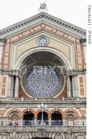 the Great Hall facade of Alexandra Palace is an architectural masterpiece composed of pale cream and rich terracotta brickwork. Its defining feature is a monumental, deep-set semicircular arch framing the Great Hall facade of Alexandra Palace is an architectural masterpiece composed of pale cream and rich terracotta brickwork. Its defining feature is a monumental, deep-set semicircular arch framing 139767461