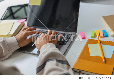 Creative professional working from home brainstorming ideas with laptop and stationery. Creative professional working from home brainstorming ideas with laptop and stationery. 139767674
