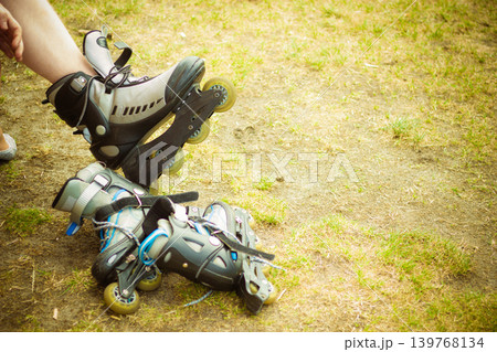 Man putting on roller skates Man putting on roller skates 139768134