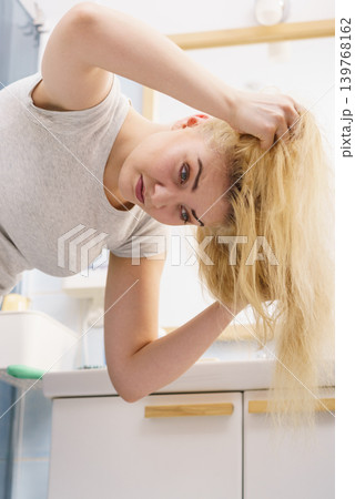 Female having problem with blonde hair Female having problem with blonde hair 139768162