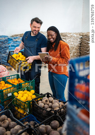 Farmers Market Workers Using Tablet for Inventory Management Farmers Market Workers Using Tablet for Inventory Management 139768759