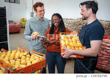 Workers checking fresh pear quality in fruit warehouse Workers checking fresh pear quality in fruit warehouse 139768790