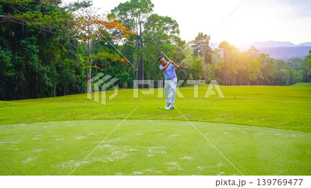 Golfers are putting golf in the evening golf course golf backglound. 139769477