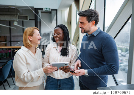 Diverse business team collaborating using digital tablet in office 139769675