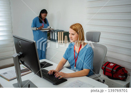Healthcare staff working at desktop computer in clinic Healthcare staff working at desktop computer in clinic 139769701