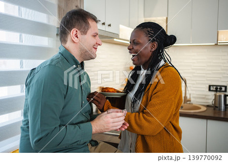 Interracial couple laughing and sharing a sweet moment Interracial couple laughing and sharing a sweet moment 139770092