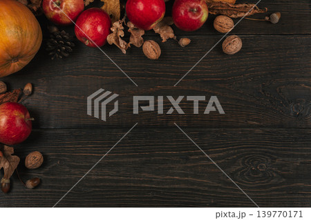 Autumn background with pumpkin, apples and nuts. Dark rustic wooden background. 139770171