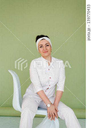 Professional Woman Doctor Sitting in Modern Clinic Professional Woman Doctor Sitting in Modern Clinic 139770433