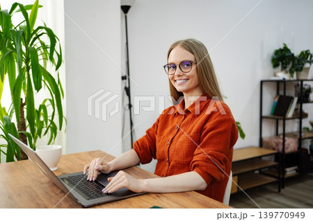 Professional woman working from home in a stylish modern office 139770949