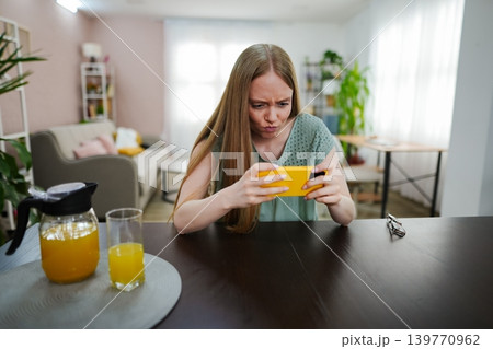Engrossed in a mobile game during a bright afternoon indoors 139770962