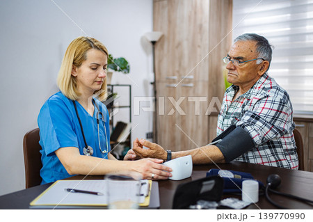 Senior man receives medical check-up in a cozy office 139770990