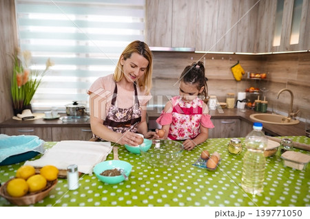 Cooking joy with mother and daughter in a cozy kitchen 139771050