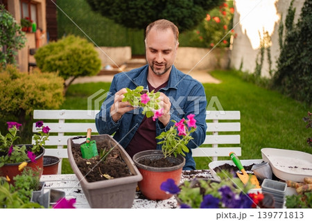Gardening joy while tending to colorful flowers outdoors 139771813
