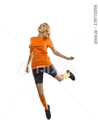 A vibrant young Indonesian southeast asian woman captured mid-air in a dynamic jump, wearing an orange t-shirt, dark shorts, and orange compression socks, isolated on a white background A vibrant young Indonesian southeast asian woman captured mid-air in a dynamic jump, wearing an orange t-shirt, dark shorts, and orange compression socks, isolated on a white background 139772056