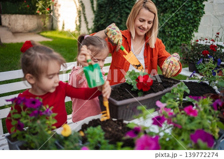 Gardening fun with children in a sunny backyard Gardening fun with children in a sunny backyard 139772274