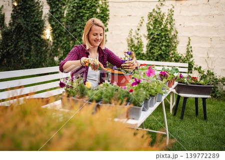 Enjoying a sunny afternoon while tending to garden plants Enjoying a sunny afternoon while tending to garden plants 139772289