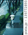 雨の朝、そろい傘の女性が駅に向かって歩いてゆく 139772893