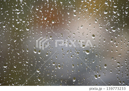 Raindrops on a window create a beautiful, blurred background Raindrops on a window create a beautiful, blurred background 139773233