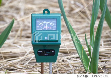 Soil Moisture Meter In Garden Mulch Next To Green Plants Measuring Moisture And Light 139773240