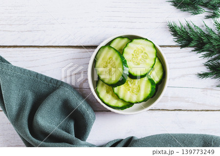 Fresh sliced cucumbers with a crispy crust in a bowl on the table top view Fresh sliced cucumbers with a crispy crust in a bowl on the table top view 139773249