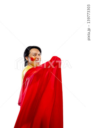 A happy Indonesian southeast asian man smiling and looking back while wrapped in a red and yellow flag. Isolated on white background, perfect for Spanish soccer, sports fans, or national pride themes 139773303