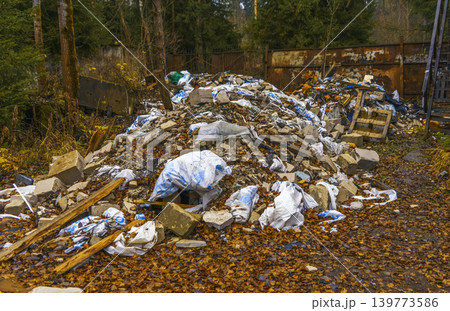 Abandoned rubbish at woods edge. Environmentally concerning scene of waste and decay in woods 139773586