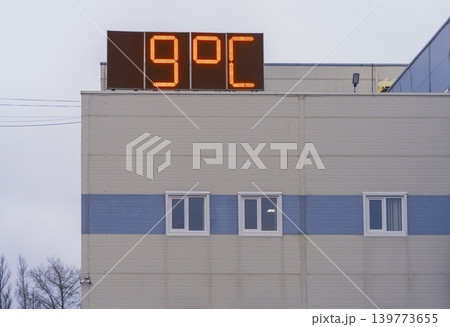 Minimalist municipal building with overcast sky and crisp winter sunlight illuminating facade 139773655