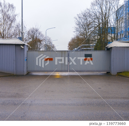Large entry point with guard booths. Secure zone featuring dual booths and controlled vehicle access 139773660