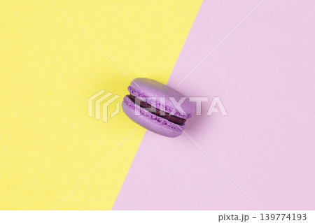 Purple french macaron on a yellow and purple background. Purple french macaron on a yellow and purple background. 139774193