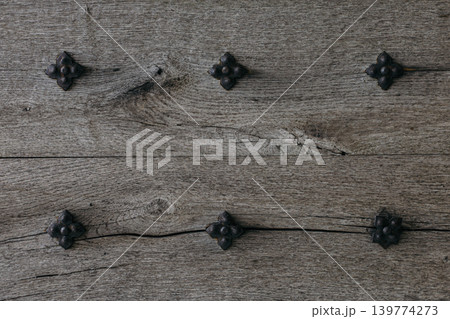Rustic wood texture or background. Old wooden door with iron rivets. 139774273