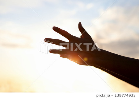 A symbolic background expressing a hopeful heart and spiritual faith at the moment of reaching out both hands toward the sky to earnestly hope and pray. A symbolic background expressing a hopeful heart and spiritual faith at the moment of reaching out both hands toward the sky to earnestly hope and pray. 139774935