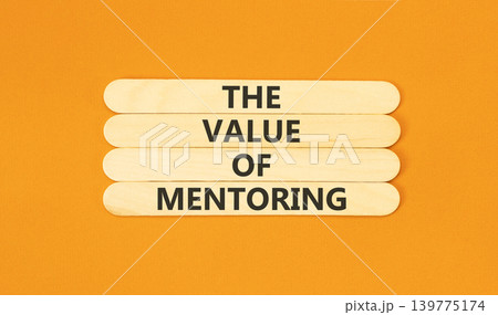 The value of mentoring words symbol. Concept words The value of mentoring on beautiful wooden sticks. Beautiful orange background. Business the value of mentoring concept. Copy space. The value of mentoring words symbol. Concept words The value of mentoring on beautiful wooden sticks. Beautiful orange background. Business the value of mentoring concept. Copy space. 139775174