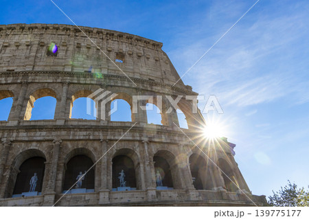 Famous Coliseum in Rome. Colosseum, or Coliseum. Sunset at huge Roman amphitheatre, Rome, Italy, Europe. Famous touristic place in the world and Europe. Beautiful blue sky background. Famous Coliseum in Rome. Colosseum, or Coliseum. Sunset at huge Roman amphitheatre, Rome, Italy, Europe. Famous touristic place in the world and Europe. Beautiful blue sky background. 139775177