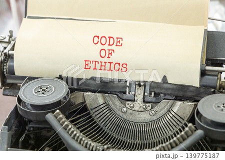 Code of ethics words symbol. Concept words Code of ethics typed on beautiful old retro typewriter. Beautiful white background. Business Code of ethics concept. Copy space. 139775187