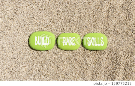Build rare skills words symbol. Concept words Build rare skills on beautiful green stones. Beautiful sand beach background. Business and build rare skills concept. Copy space. Build rare skills words symbol. Concept words Build rare skills on beautiful green stones. Beautiful sand beach background. Business and build rare skills concept. Copy space. 139775215