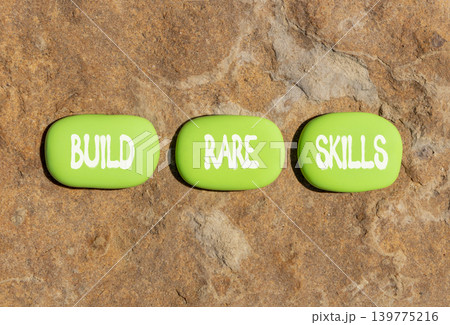 Build rare skills words symbol. Concept words Build rare skills on beautiful green stones. Beautiful stone beach background. Business and build rare skills concept. Copy space. Build rare skills words symbol. Concept words Build rare skills on beautiful green stones. Beautiful stone beach background. Business and build rare skills concept. Copy space. 139775216