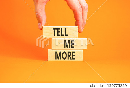 Tell me more words symbol. Concept words Tell me more on beautiful wooden blocks. Beautiful orange background. Businessman hand. Business and tell me more concept. Copy space. Tell me more words symbol. Concept words Tell me more on beautiful wooden blocks. Beautiful orange background. Businessman hand. Business and tell me more concept. Copy space. 139775239